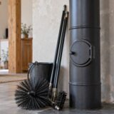 Conduit de poêle avec trappe de ramonage fermée et hérisson posé au sol